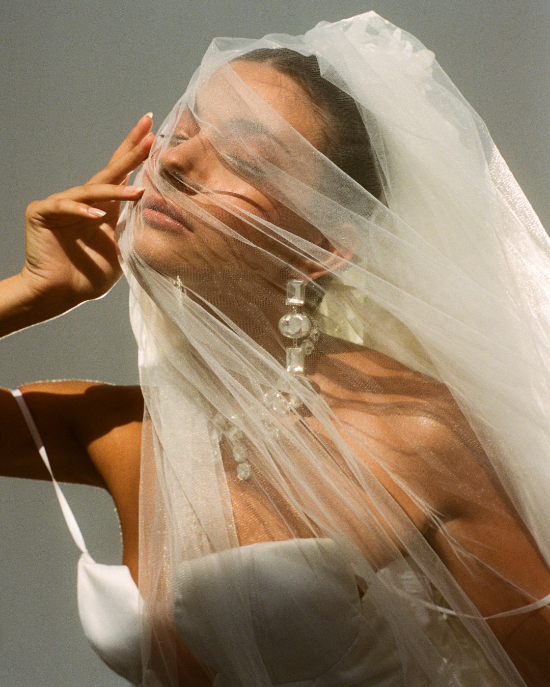 Veiled portrait, hand at the temple