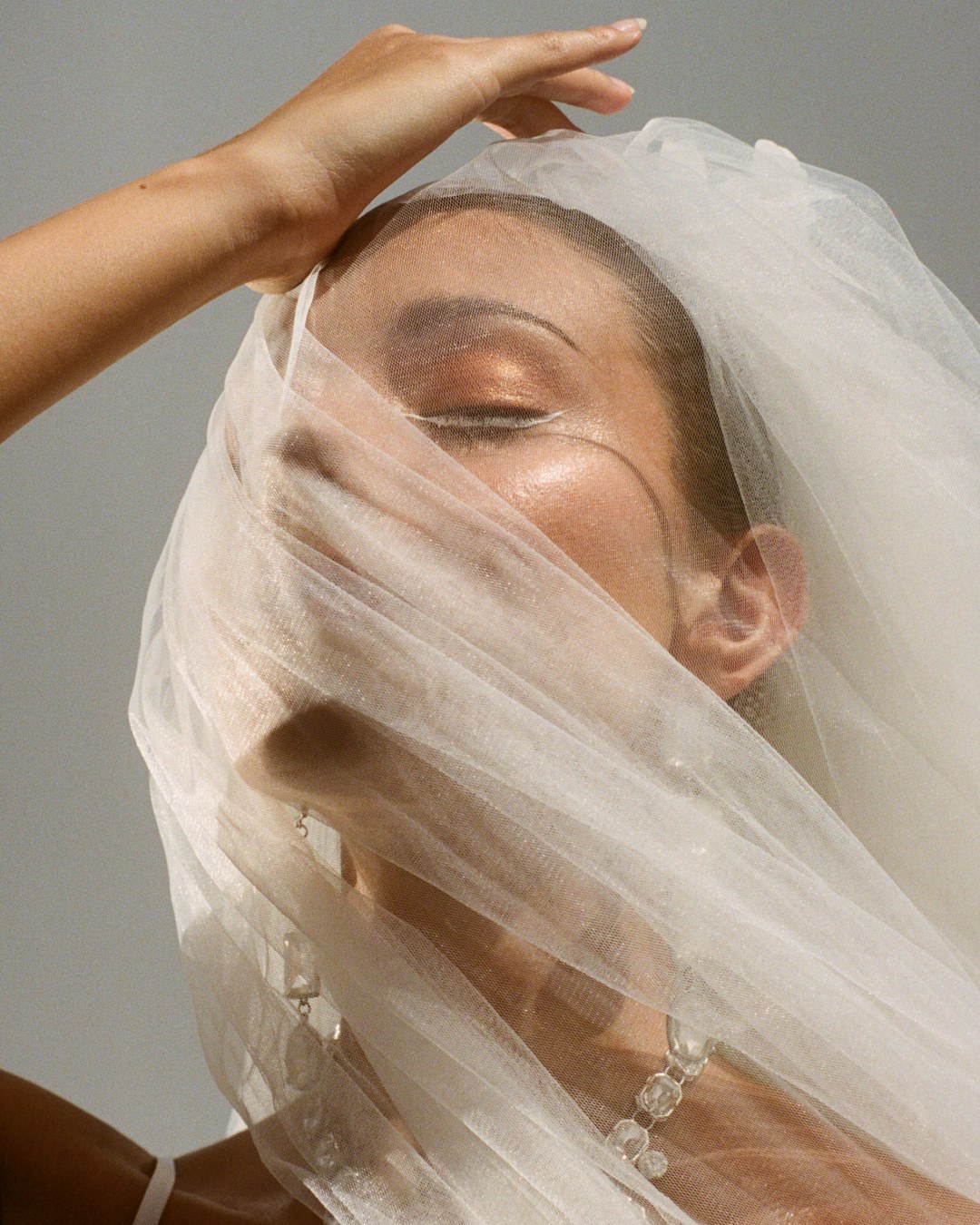 Veiled portrait in window light